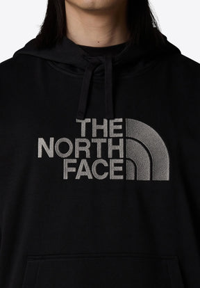 Felpa nera con logo grigio ricamato di grandi dimensioni con la scritta "THE NORTH FACE" e un design semicircolare. Include una tasca frontale e cappuccio regolabile.