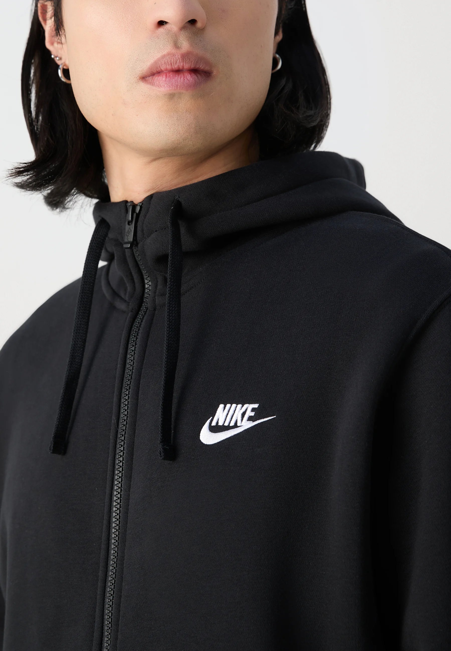 Felpa nera con zip realizzata in cotone con una finitura texturizzata. Presenta un cappuccio con cordini e un piccolo logo Nike bianco sul petto.